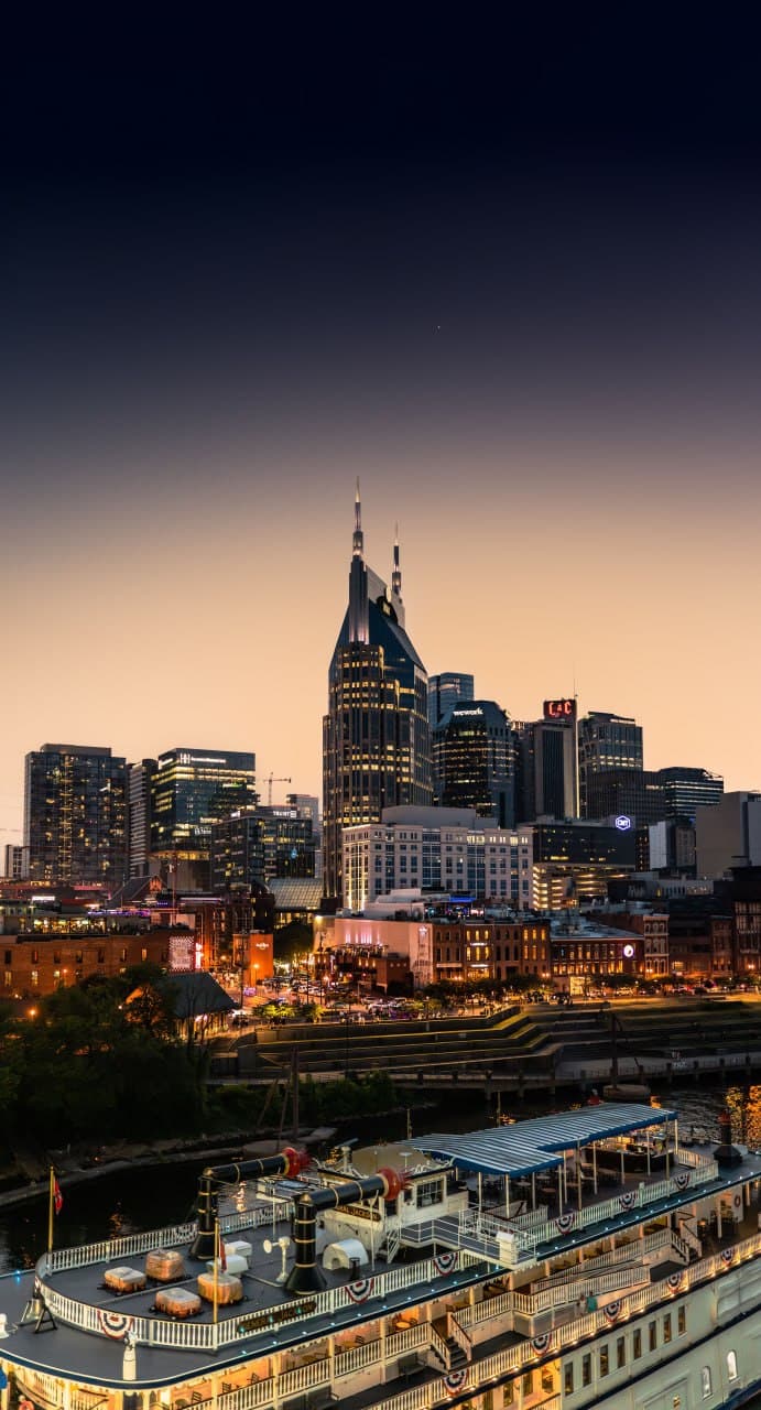 Nashville riverfront skyline at dusk with the General Jackson showboat
